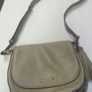 Michael Kors Grey purse with 2 tassels, crossbody, outside pocket, flap boho